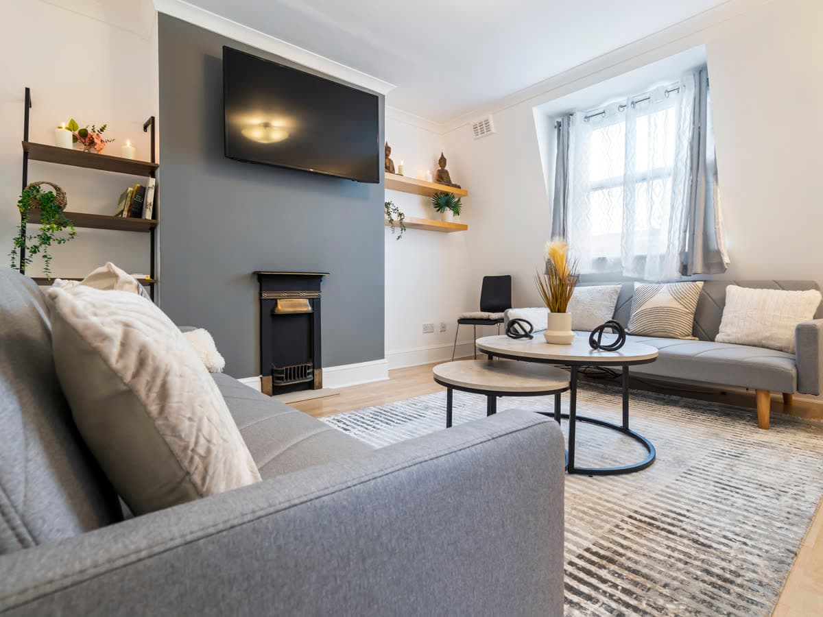 Living room with a period fireplace in the Maida Vale apartment we operate